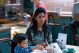 Suki Panesar sitting with grandson Tye in the cafe