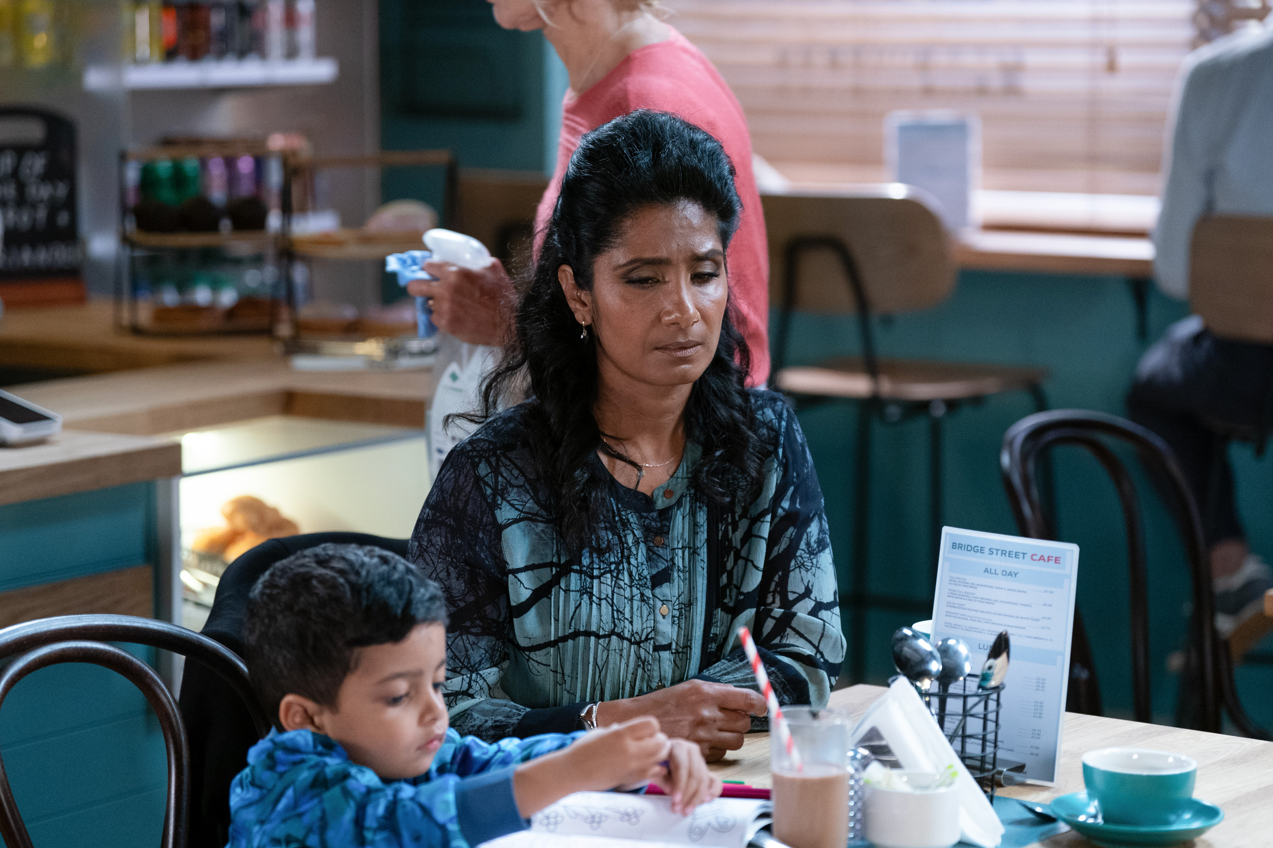 Suki Panesar sitting with grandson Tye in the cafe