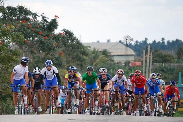 The peloton crests a hill