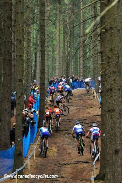 Riders struggle on the wet roots on one of many climbs in the forest