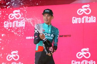 Lennard Kämna (Bora-Hansgrohe) celebrates on the podium at the Giro d'Italia after winning stage 4 on Mount Etna