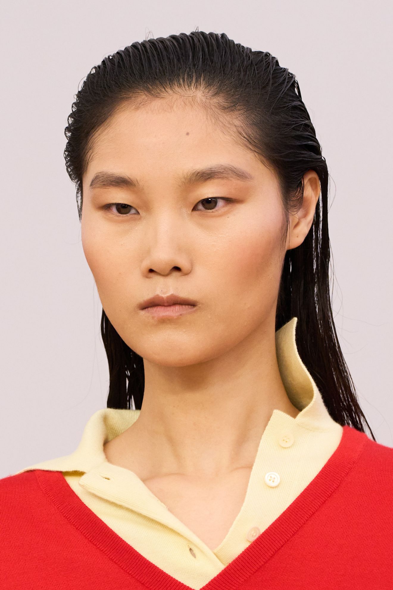 A model at the SS26 Loewe Paris show with slicked back hair