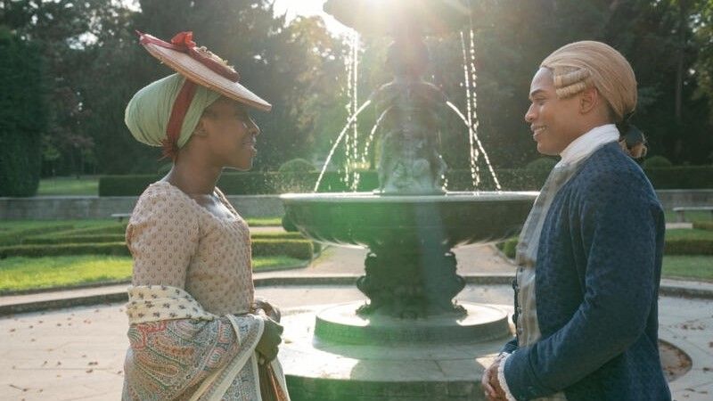 Ronke Adekoluejo and Kelvin Harrison Jr. stand by a fountain in Chevalier