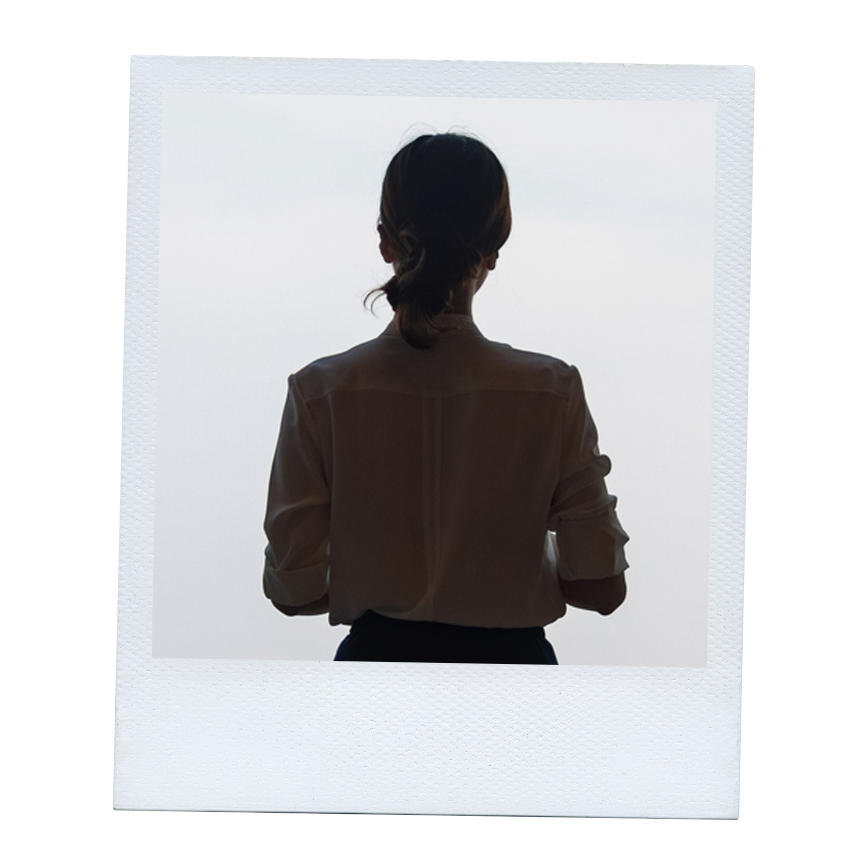 Polaroid of woman from behind wearing a tan sweater with her hair in a ponytail