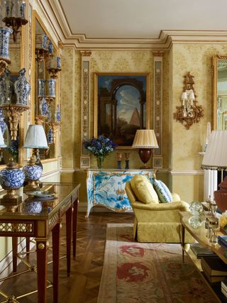 Opulent yellow/gold living room detail in apartment by Timothy Corrigan