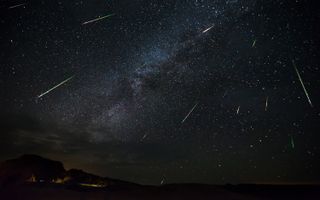 Bright green meteors dart across the sky in this photo of the Perseid meteor shower over Terlingua, Texas on Aug. 14, 2016.