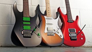 Three Ibanez guitars against a white wall