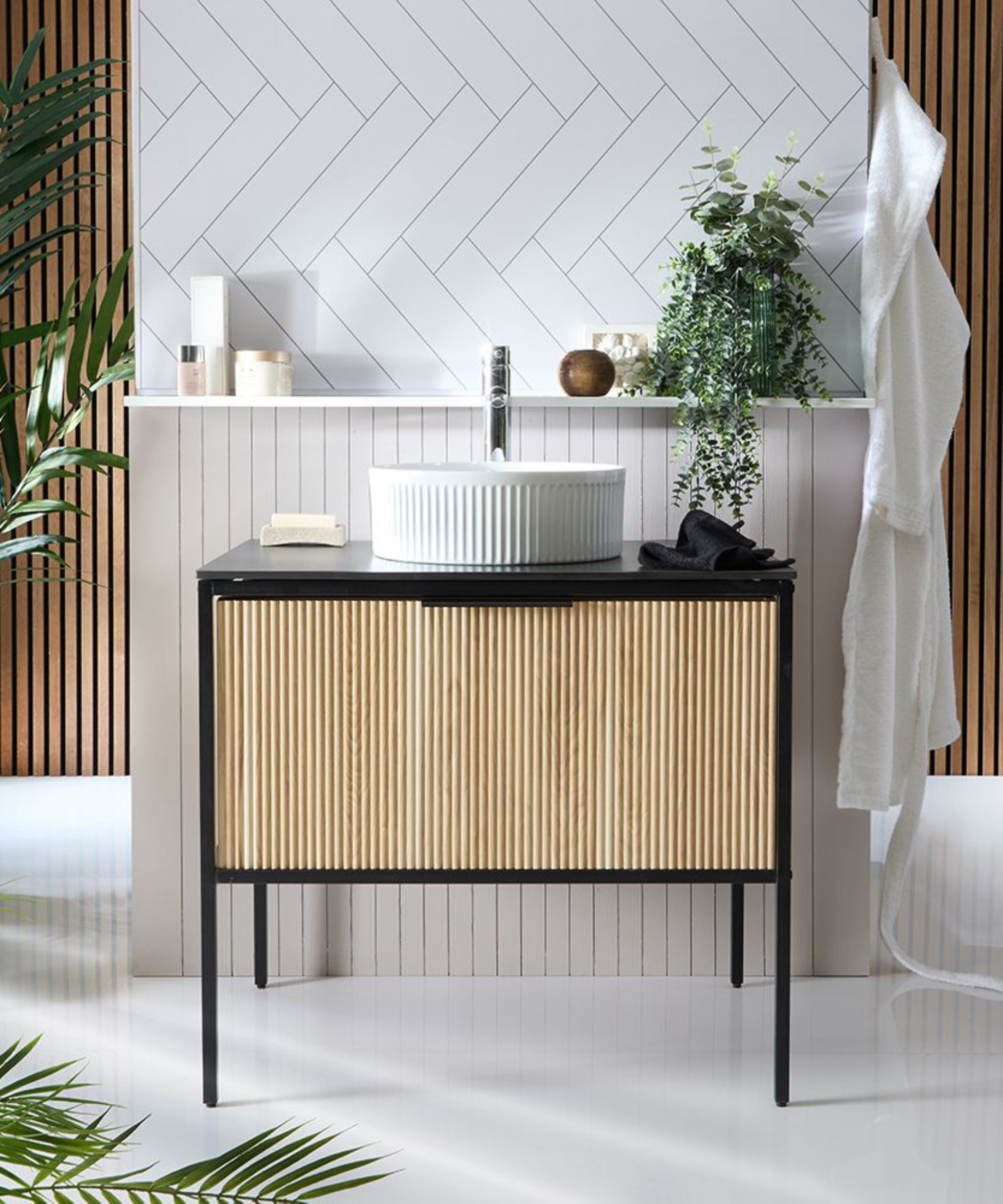 vanity unit with wooden fluted door, white sink against partion white tiled wall