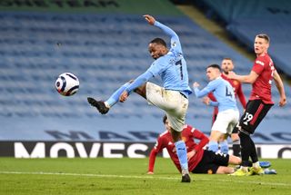 Raheem Sterling attempts a shot on goal in the Manchester derby