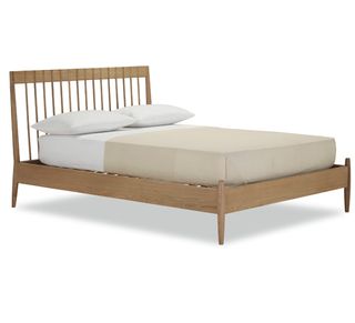 wooden bed with white mattress and pillows