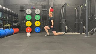 TechRadar fitness writer Harry Bullmore performing a kettlebell single-arm overhead lunge