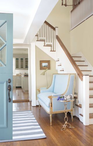 staircase with a turn in light airy hallway