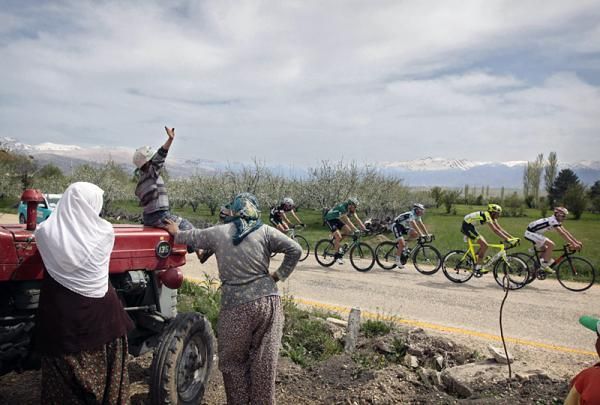 The peloton passes some spectators during stage 3.