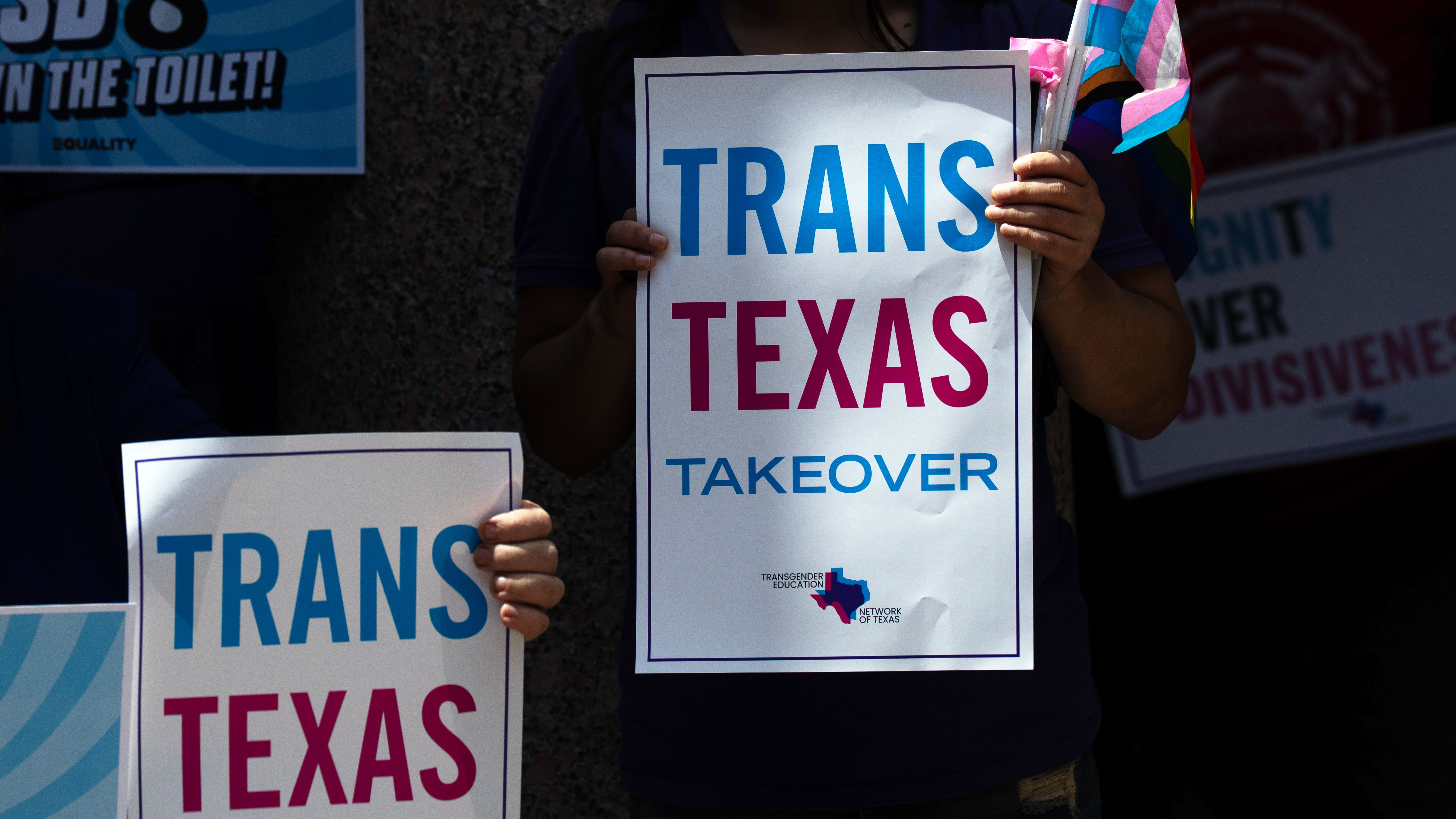 Trans rights activists holding placards in Texas