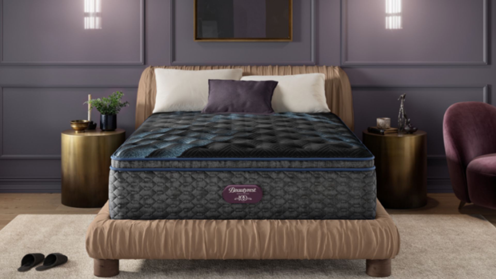 Grey and blue Beautyrest mattress on beige textured bed base in bedrrom with purple panelled wall, gold bedside tables and purple cushion.