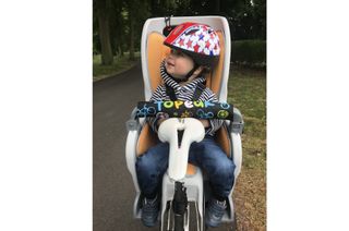 Topeak Babyseat II is shown front on with a child sitting inside