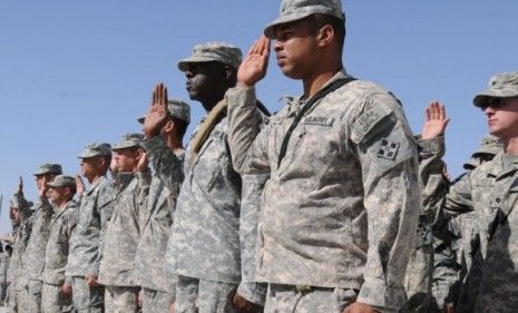 Soldiers stand in salute in Afghanistan: though bin Laden&amp;#039;s decade-long terrorism didn&amp;#039;t completely bankrupt the U.S. the wars have been costing trillions.