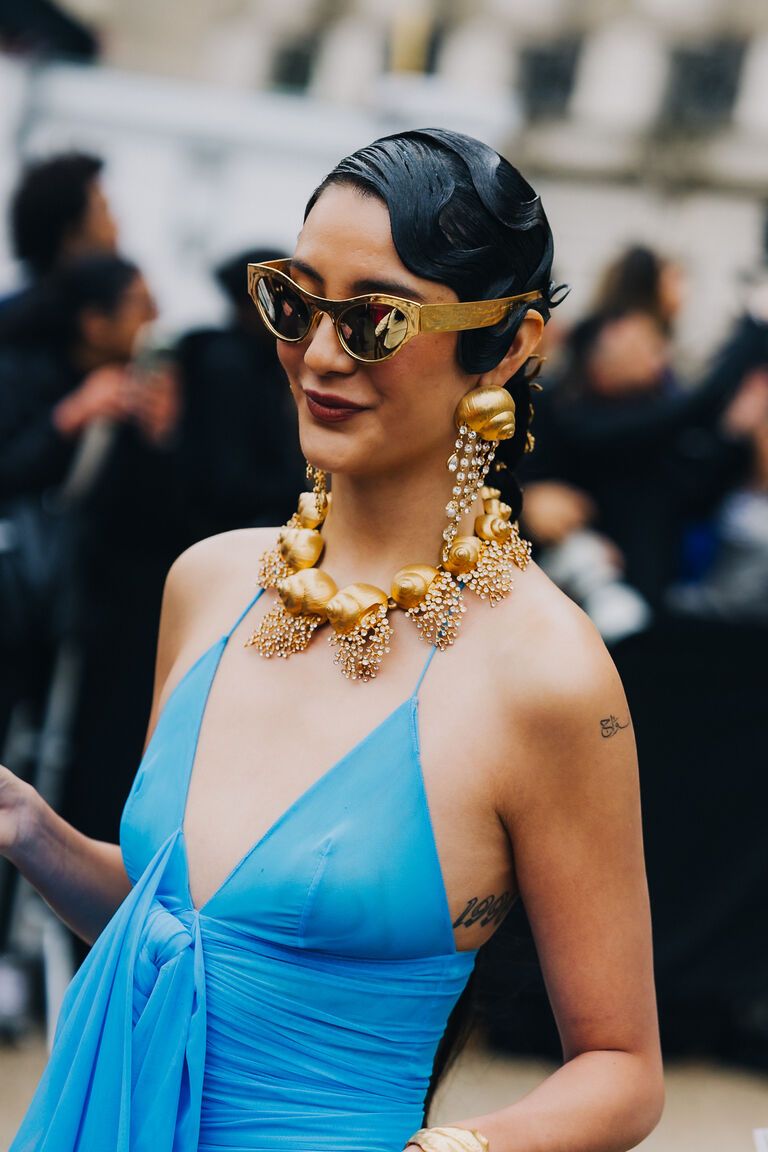 a woman wearing the shell motif jewelry summer 2026 trend at fashion week