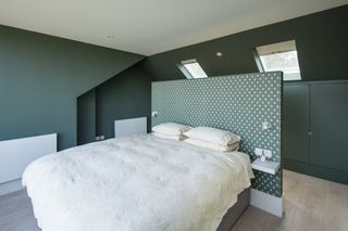dark green bedroom with room divider for walk in wardrobe