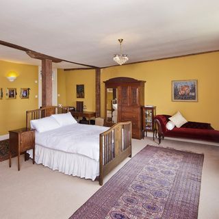 bedroom with yellow wall and white flooring