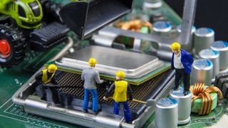 Tiny toys team of engineers repairing circuit mother board computer