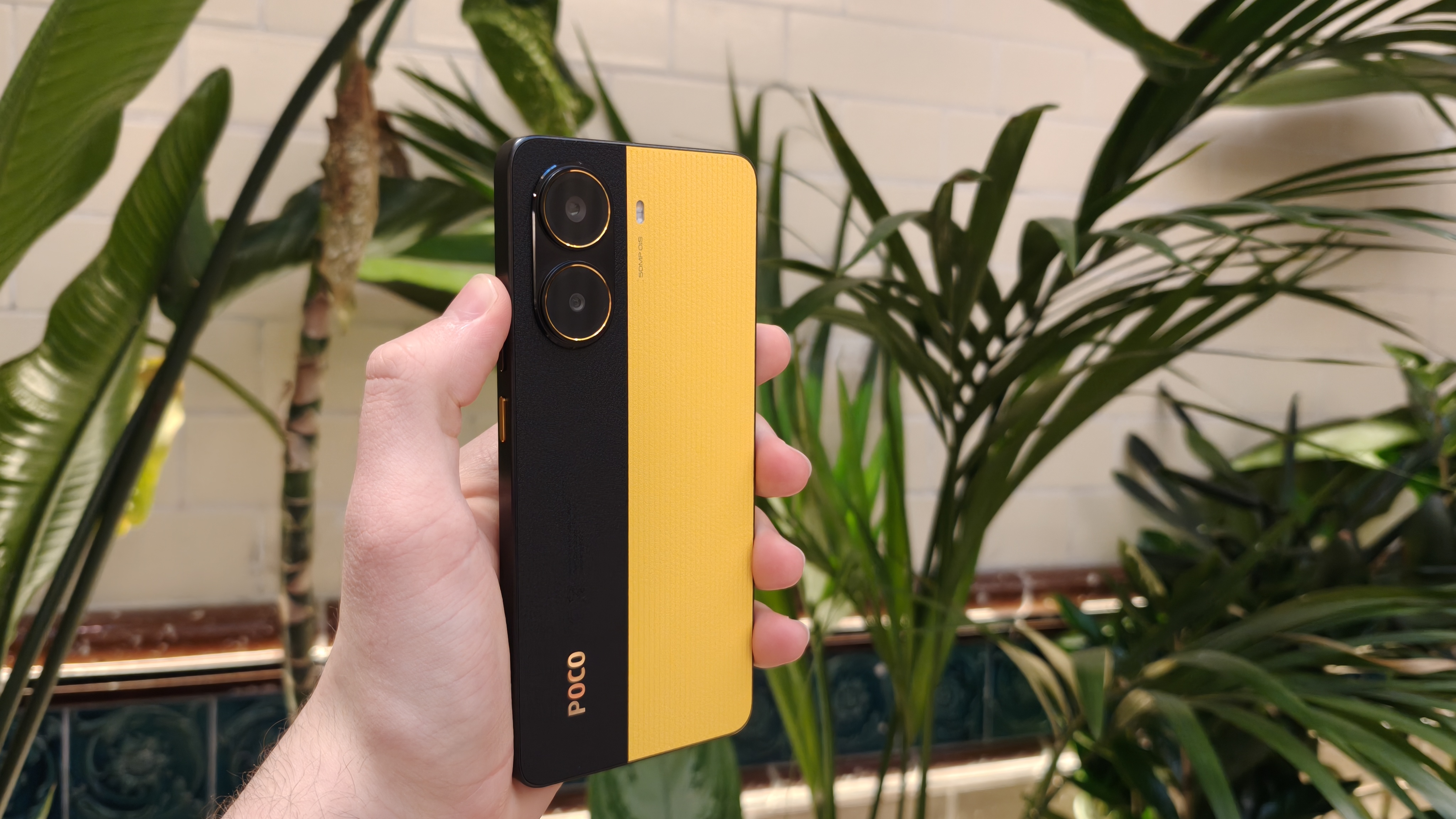 The Poco X7 Pro against a houseplant