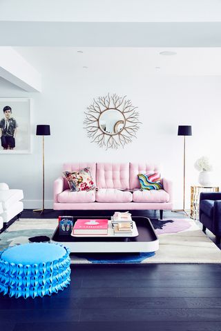 A black and white living room with a dusty pink sofa