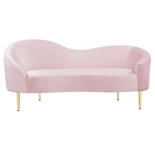 A wavy pastel pink velvet sofa