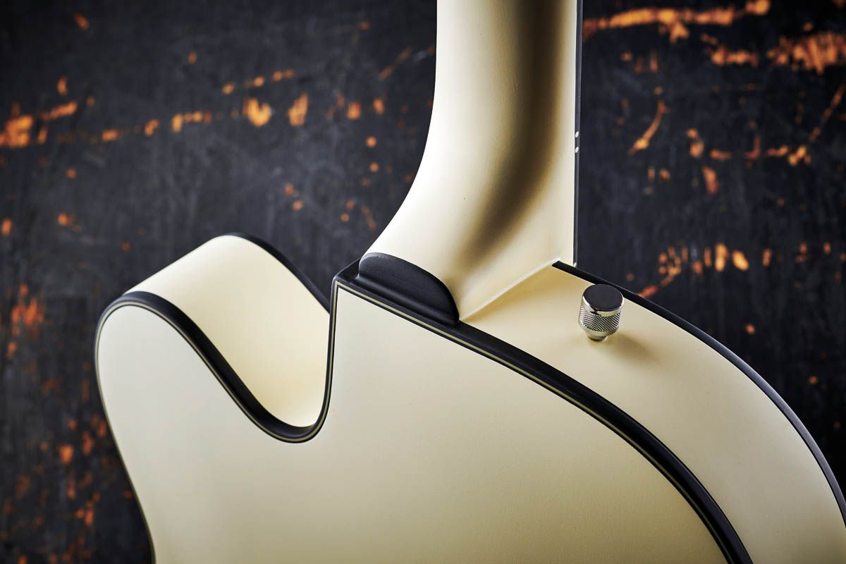 The laminated maple body is bound in aged white plastic and black purfling