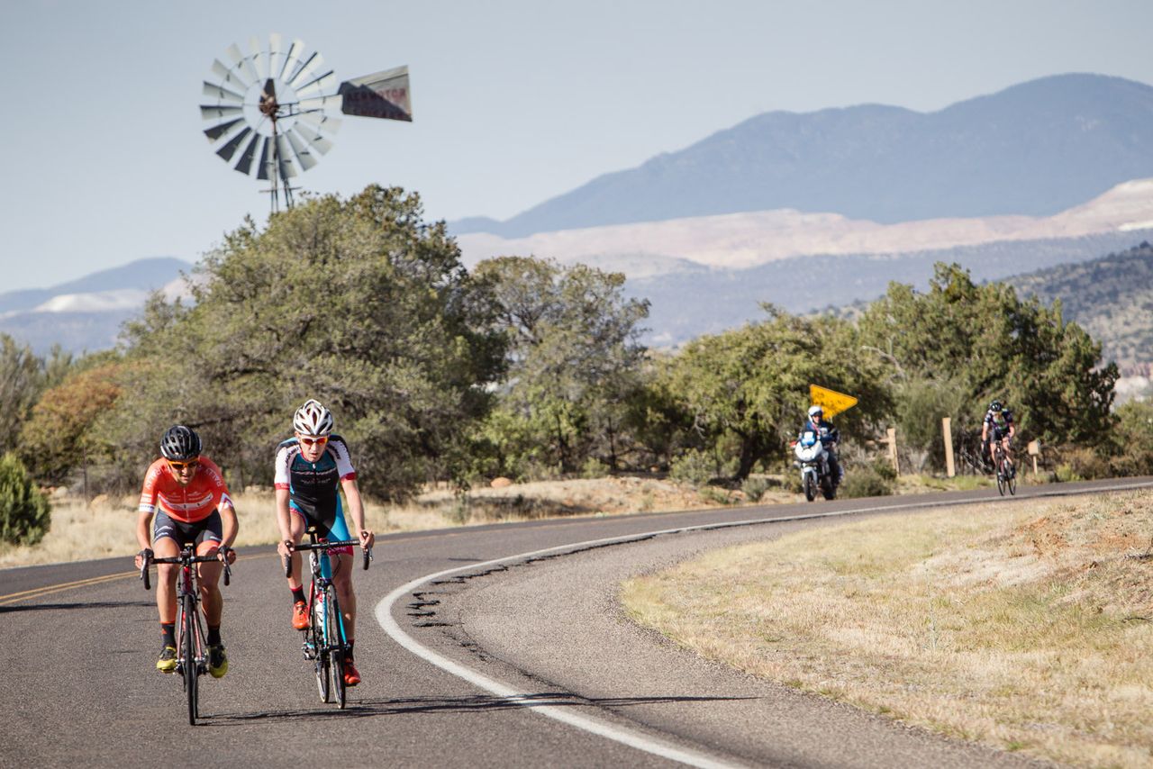Two riders get off the front of the mens field