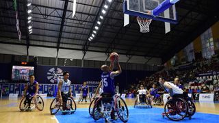 Person taking a shot during a wheelchair basketball game