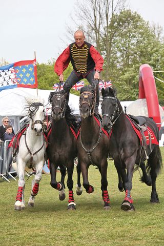 Karl Greenwood of the Stampede Stunt Company performs one of Astley's signature tricks