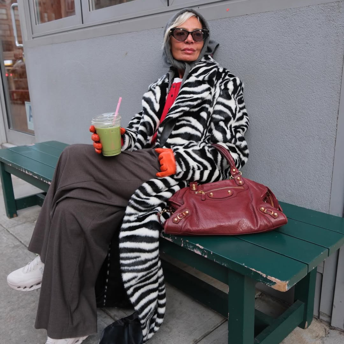 @greceghanem wears zebra print coat and grey trousers