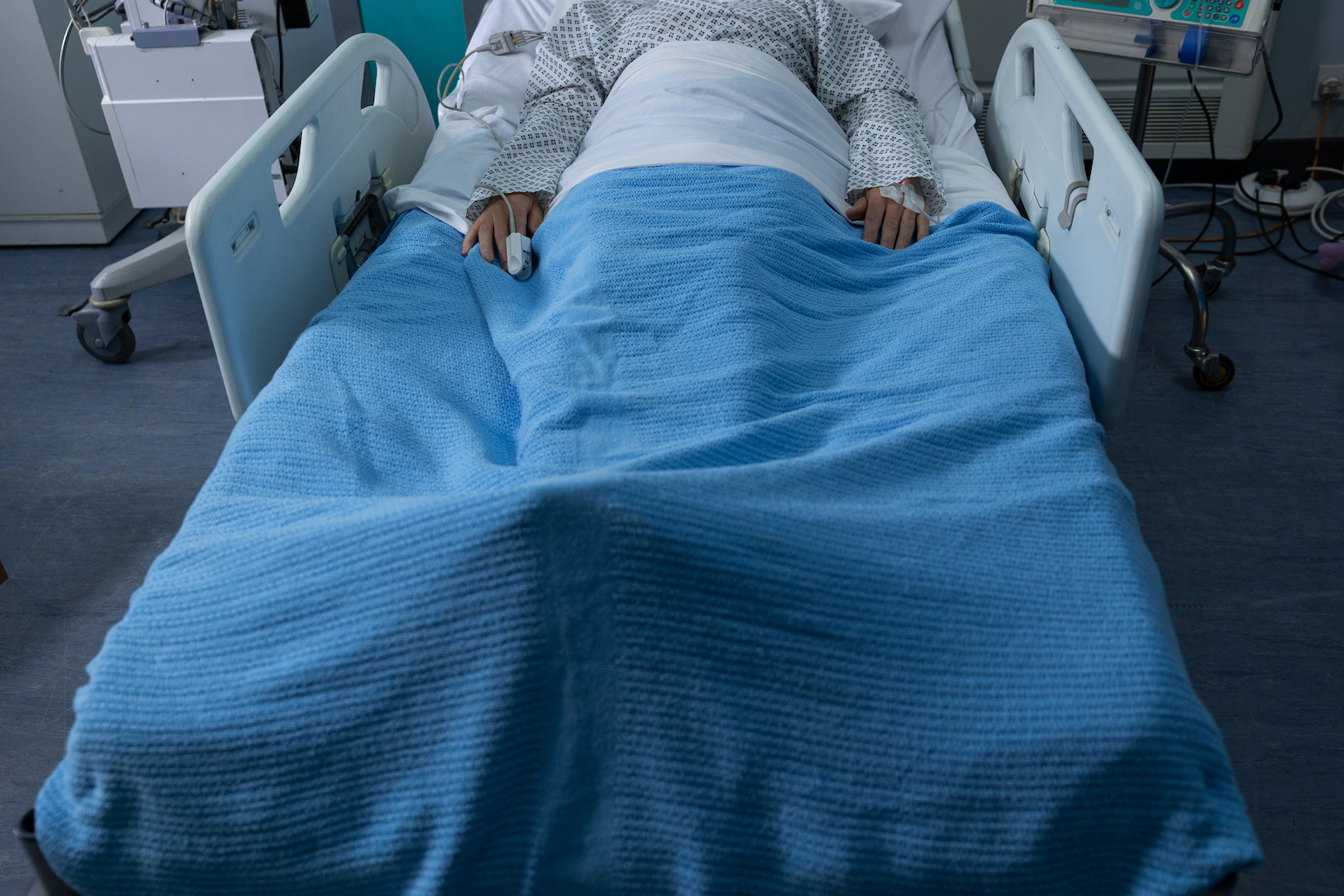 mystery patient lying in hospital bed.