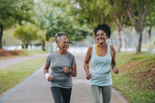 Two women run in a park