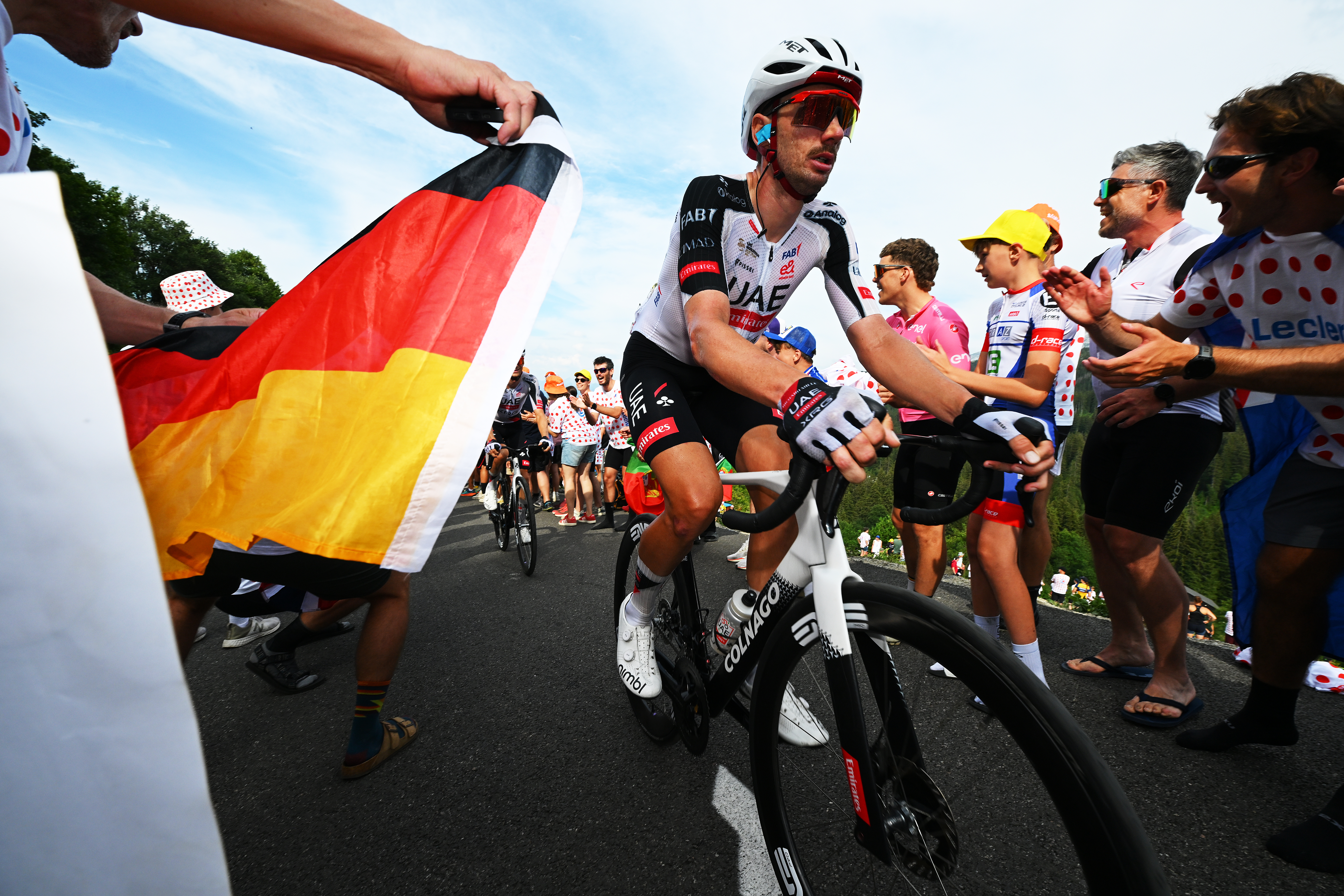 Brandon McNulty of United States and UAE Team Emirates - XRG competes while fans cheer at the Plateau de Solaison (1501m) during the Tour de France 2026
