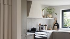 a kitchen with a trapeze shaped built in cooker hood over a ranger cooker