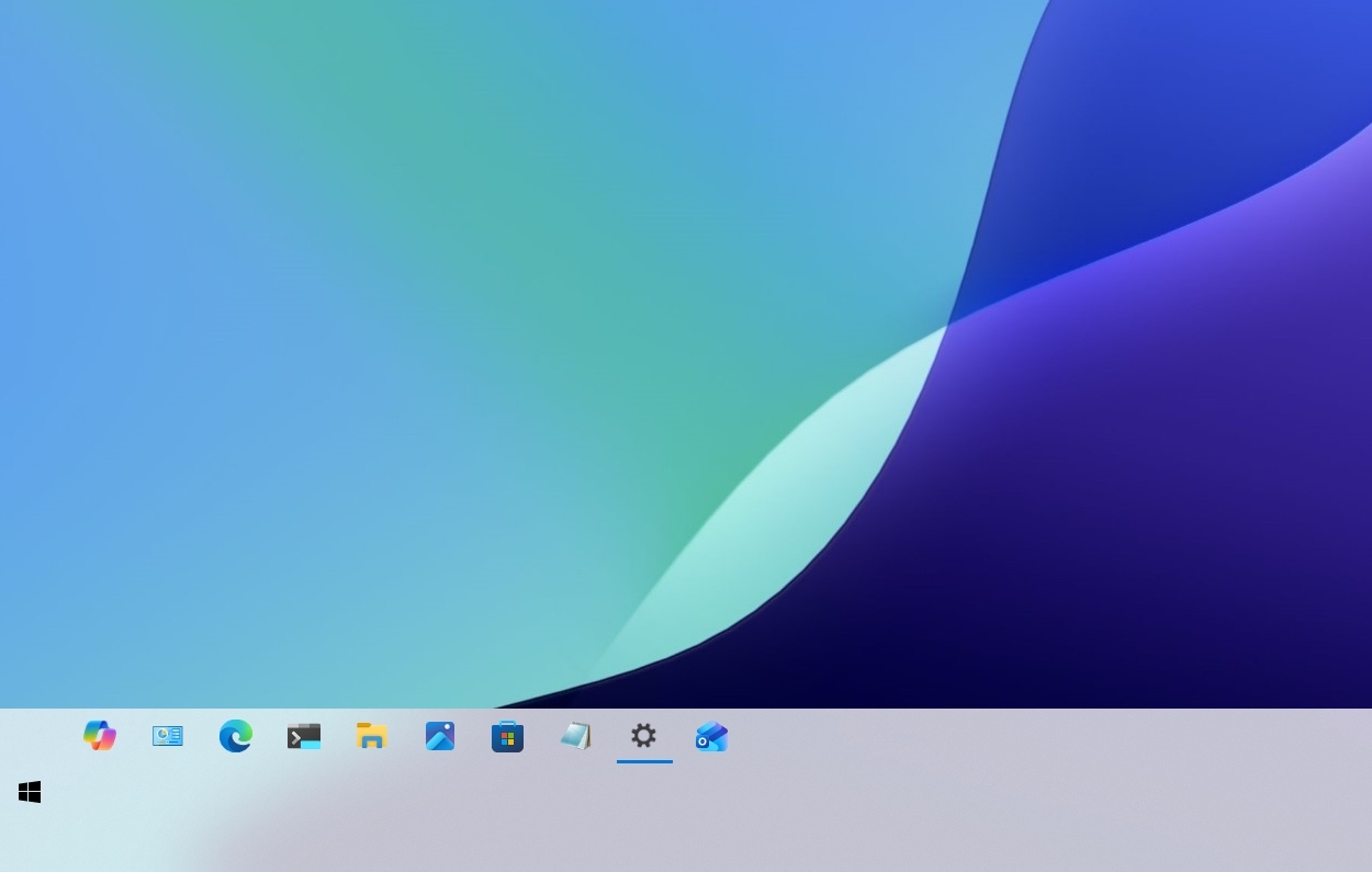 A digital desktop screen features a smooth gradient background of blue, green, and purple hues. The taskbar shows various application icons, creating a modern and minimalist look.