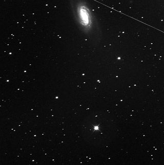 Two telescopes operated by astronomers at the Marshall Space Flight Center just stopped scanning the skies for Comet Elenin, which began fading and breaking apart back in August. Now only empty space marks its close approach (22 million miles) to Earth. However, a meteor and the barred spiral galaxy NGC-2903 grace the top of this October 14, 2011, image.