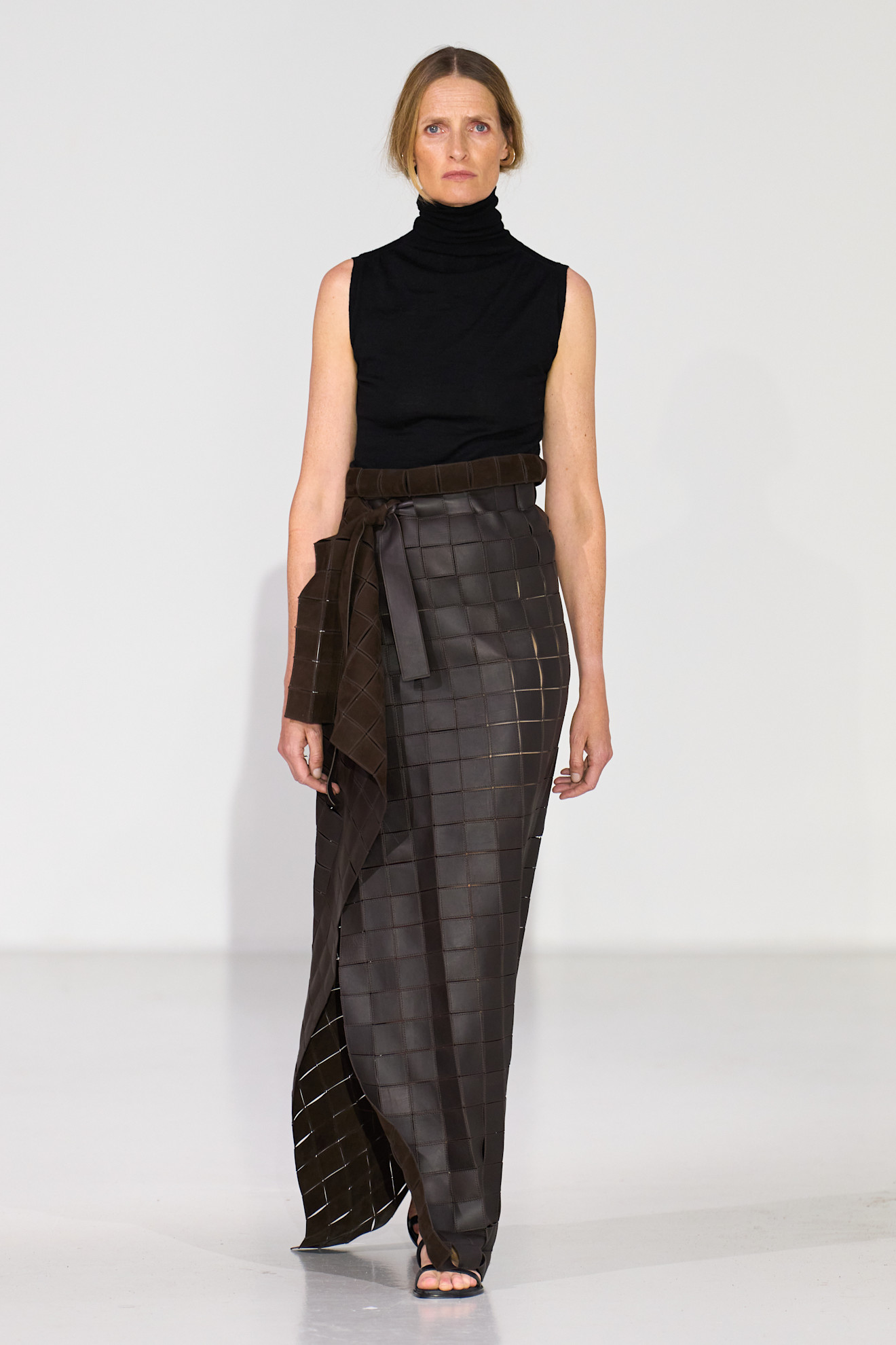 Models wear knitted clothes on the spring and summer 2026 runway.