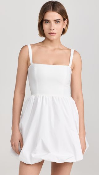 Model is wearing a white sleeveless bubble hem dress