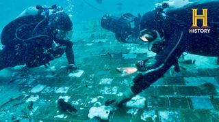 Underwater explorer and marine biologist Mike Barnetteand wreck diver Jimmy Gadomskiexploring a twenty-foot segment of the 1986 Space Shuttle Challenger