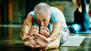 Senior man stretching during yoga