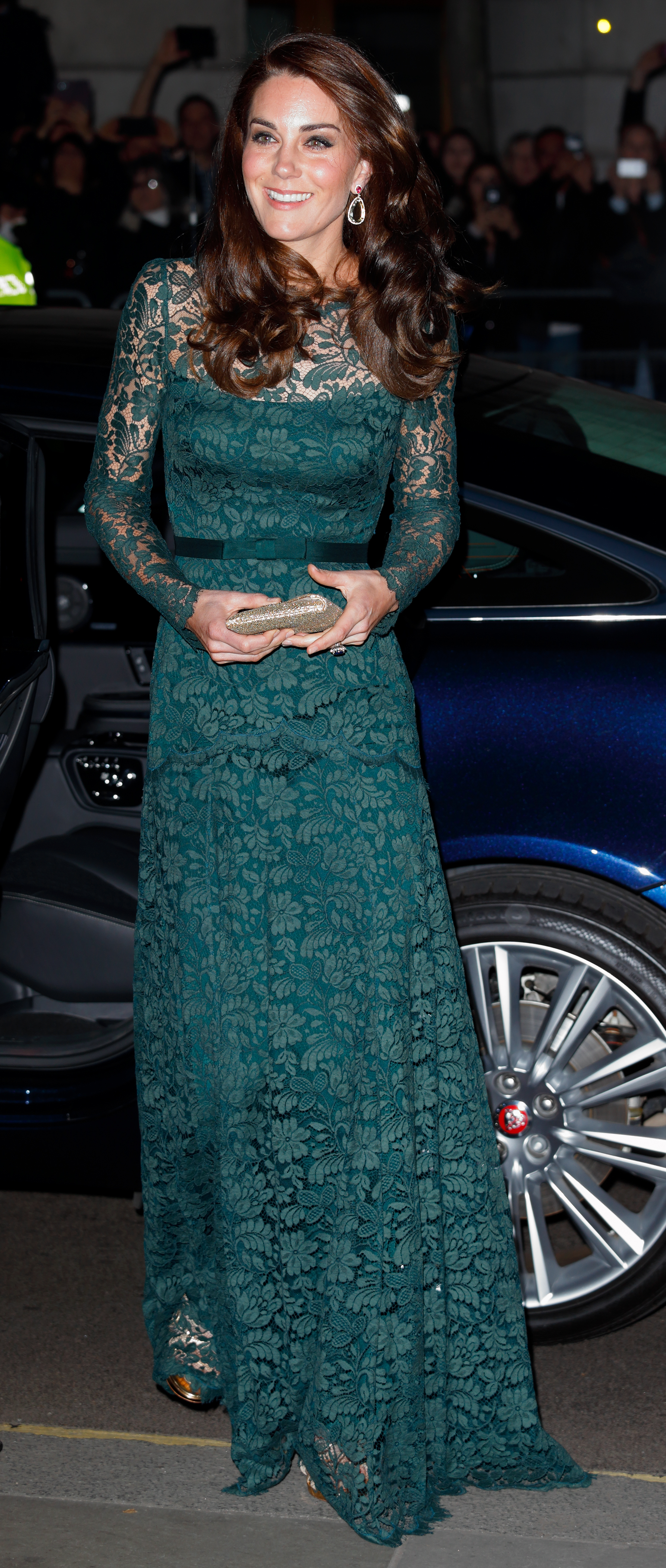 Princess Kate wearing a green lace dress standing in front of a car