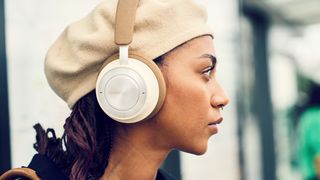 Dali IO-8 headphones worn by a woman on a train