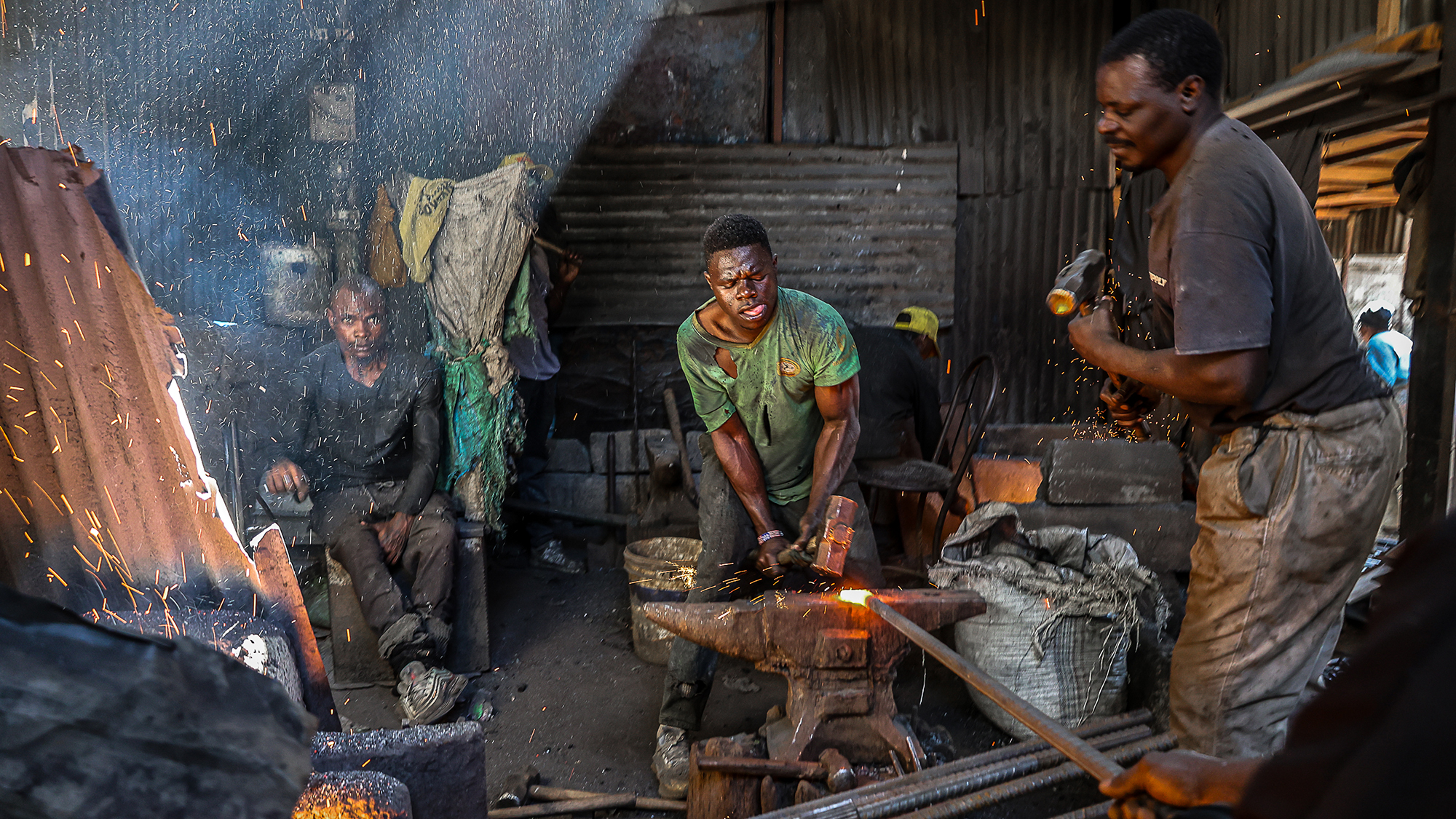 A blacksmith shapes a farm tool at a Jua Kali workshop in the Kamkunji neighborhood of Nairobi, Kenya
