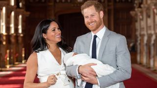 Prince Harry, Duke of Sussex and Meghan, Duchess of Sussex, pose with their newborn son Archie Harrison Mountbatten-Windsor during a photocall in St George's Hall at Windsor Castle on May 8, 2019 in Windsor, England.