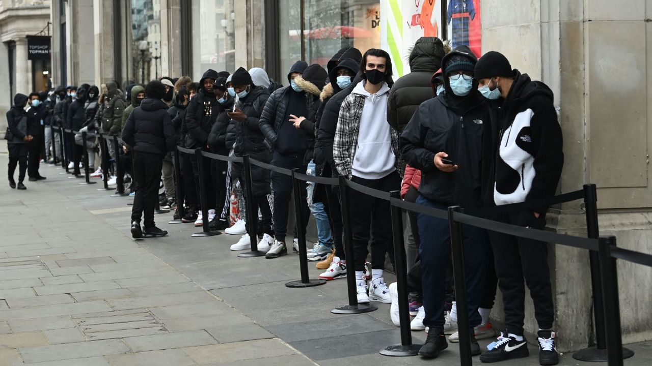 Shoppers queue outside a Nike store in central London on 12 April 