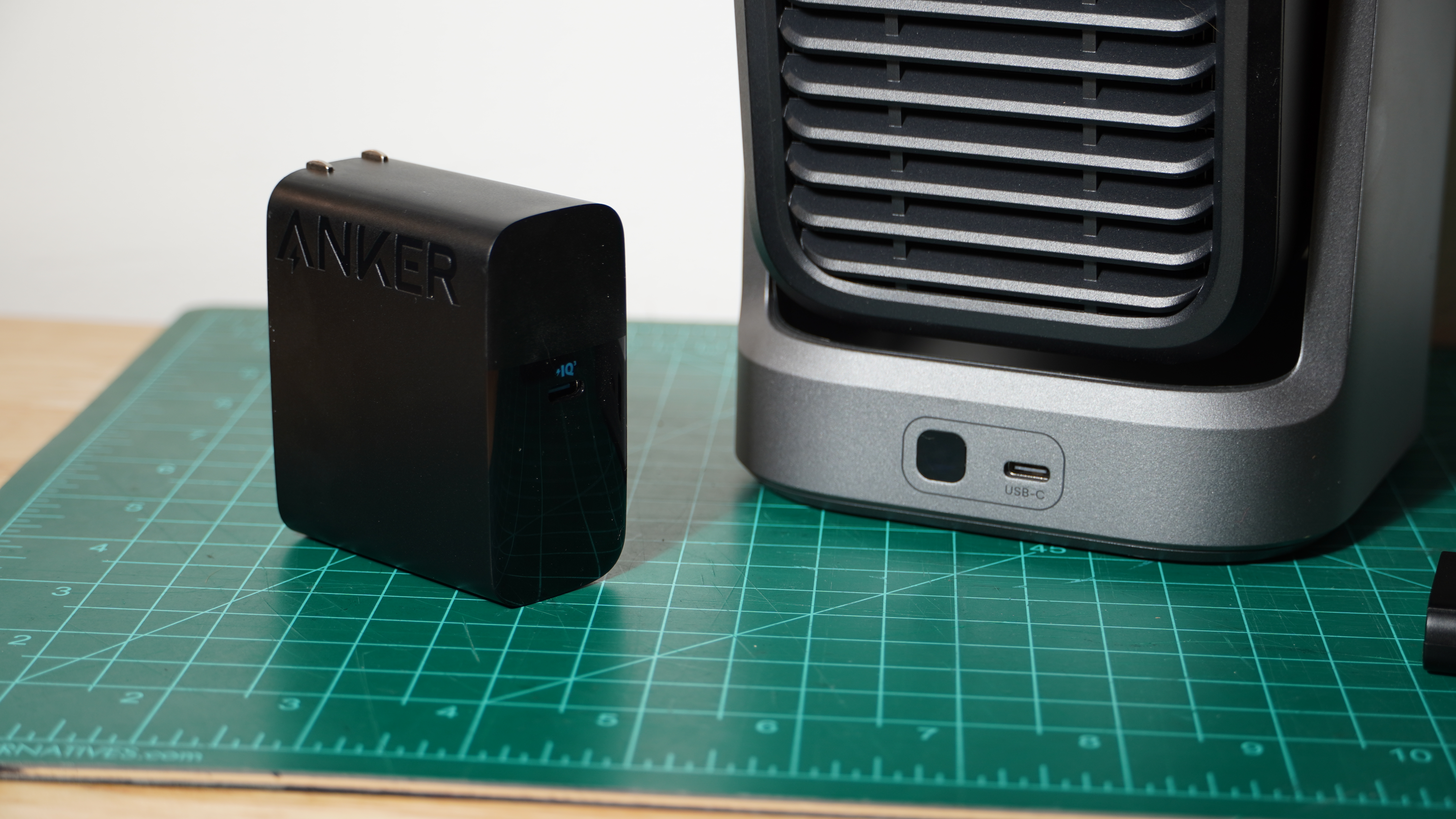 A close up of the Soundcore Nebula P1 projector and one of its wireless speakers