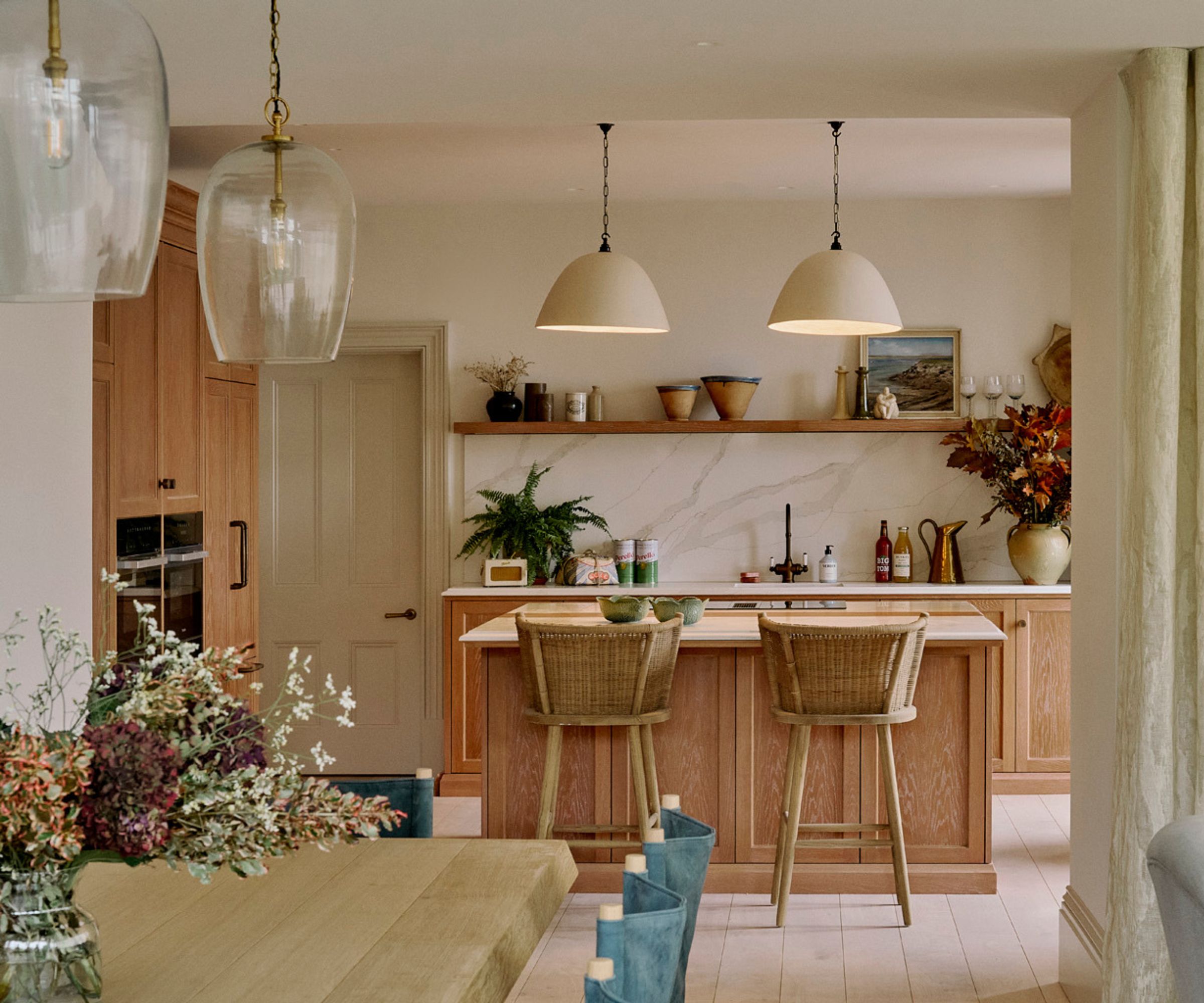 A wooden kitchen with marble countertops